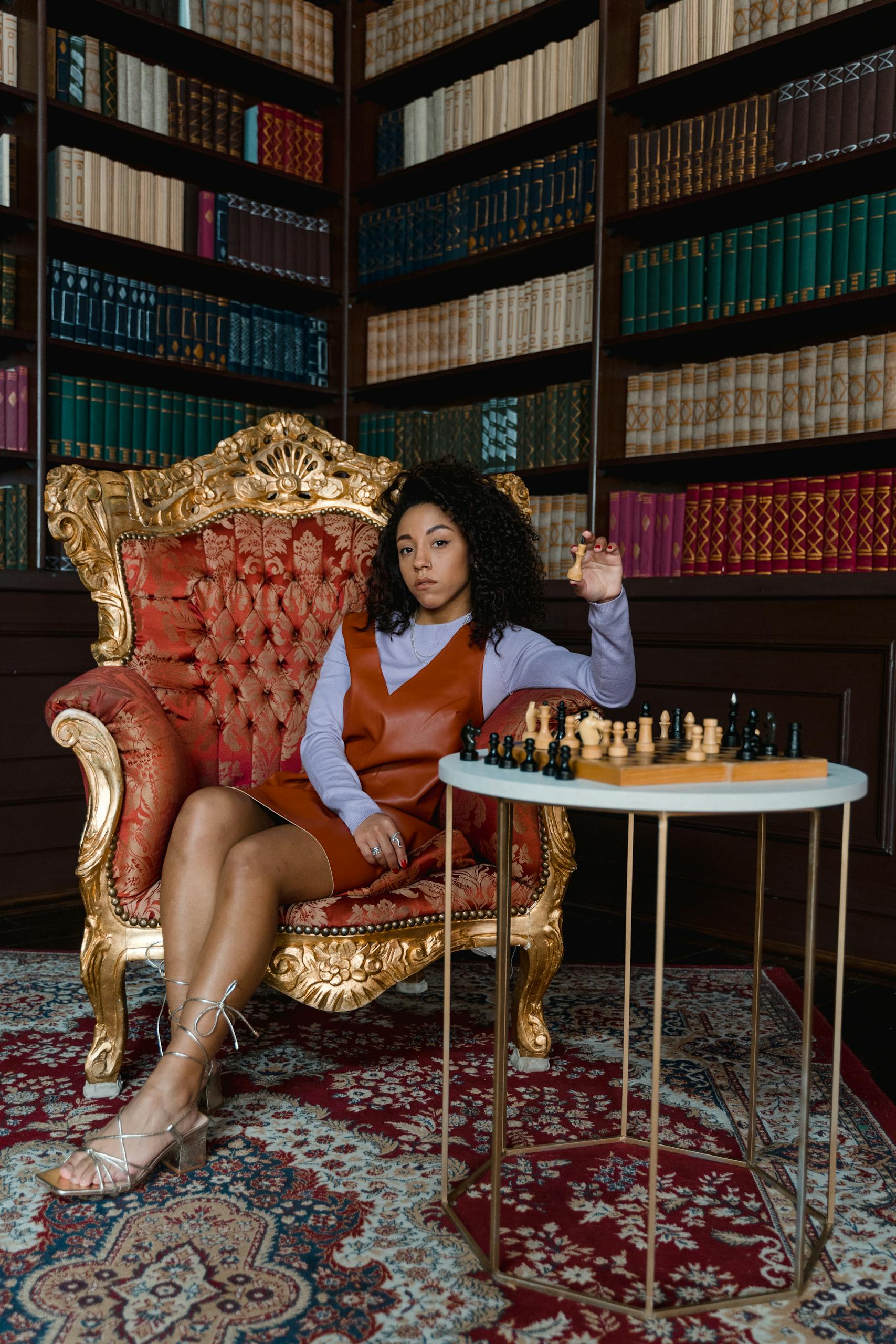A thoughtful woman sitting in a luxurious library playing chess, strategizing her next move.